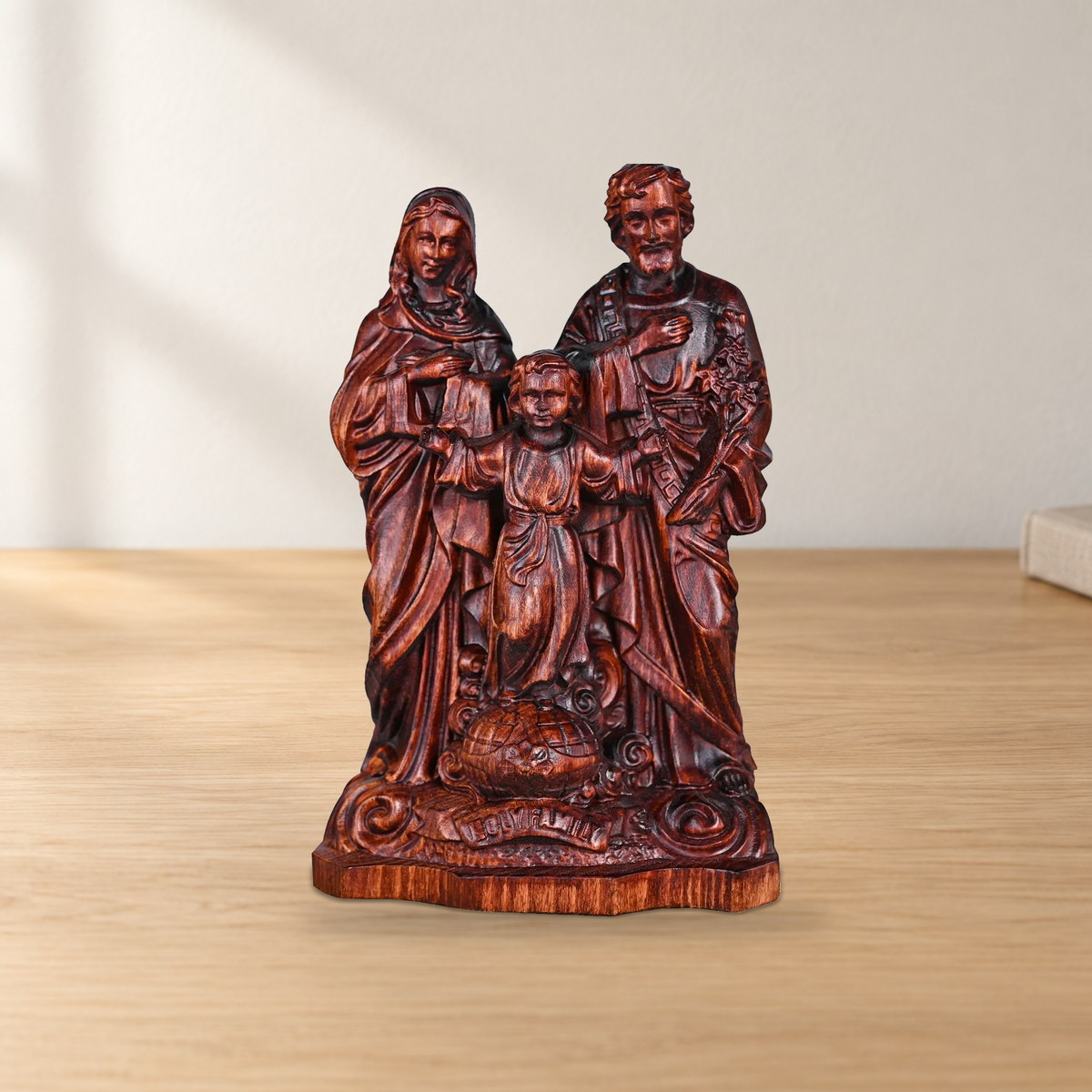 Holy Family beechwood sculpture on a light wooden tabletop.