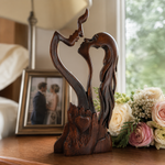 Retro Color wooden couple sculpture beside a frame and flowers in a styled scene