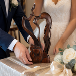 Wooden couple sculpture in a wedding-inspired scene; accessories not included