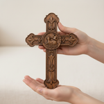 Hands holding cross front view